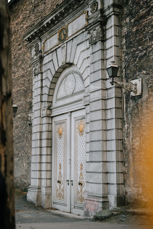 a very old building with two gates and a few lights