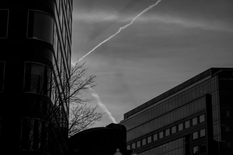 the jets are flying in the cloudy sky near a building