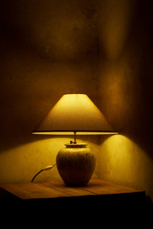 lamp with light in a dark room on table