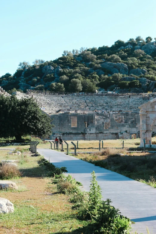 a path running up towards some ruins in the background