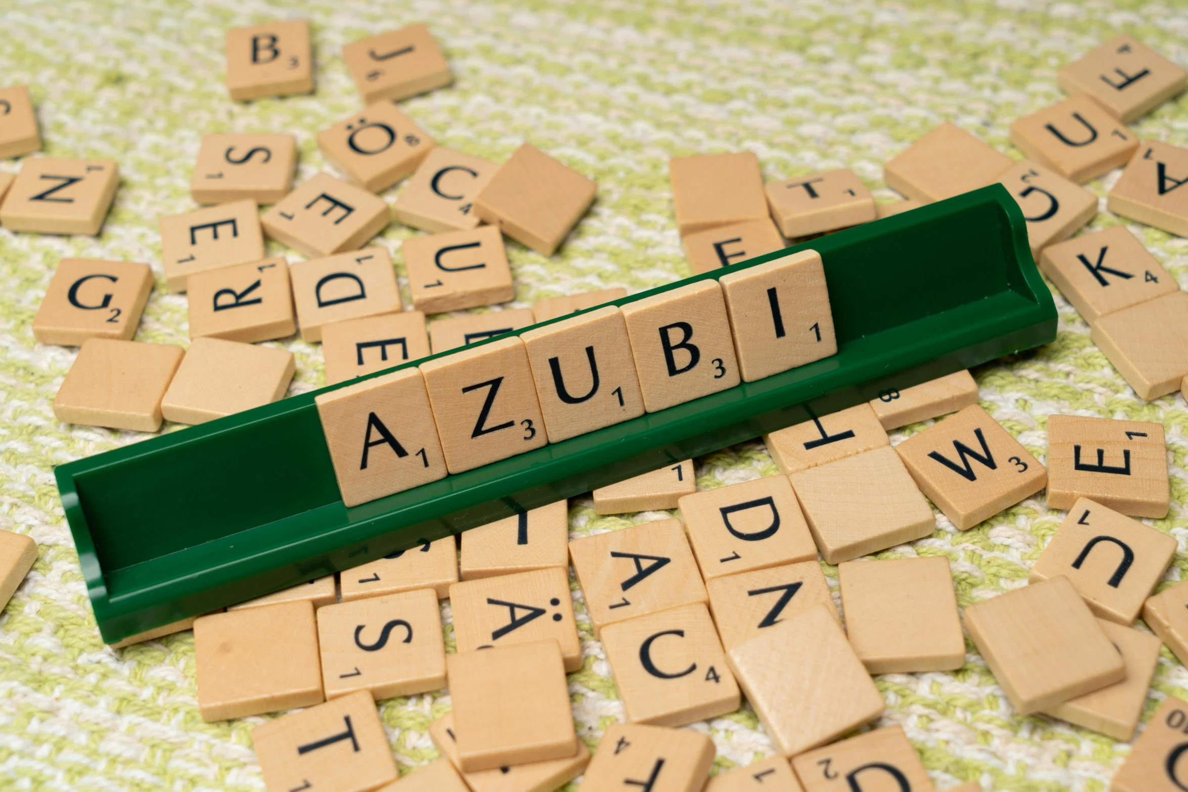 a lot of scrabbled wooden letters and letters spelling out azubit