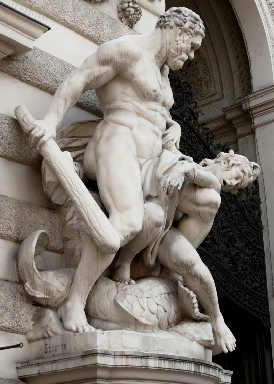 a statue is sitting in front of the door of a building