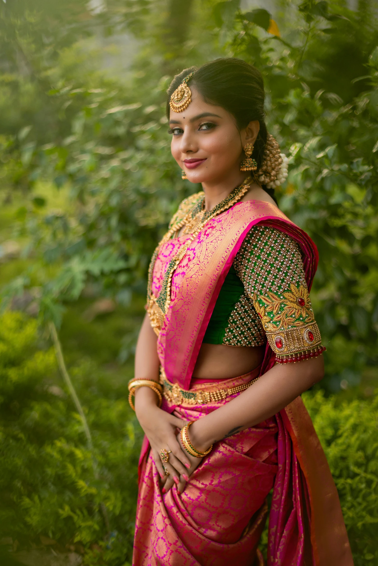 a young lady wearing an ethnic indian outfit poses for the camera