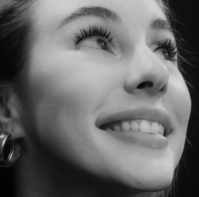 closeup of a woman with the eye lashes curled back