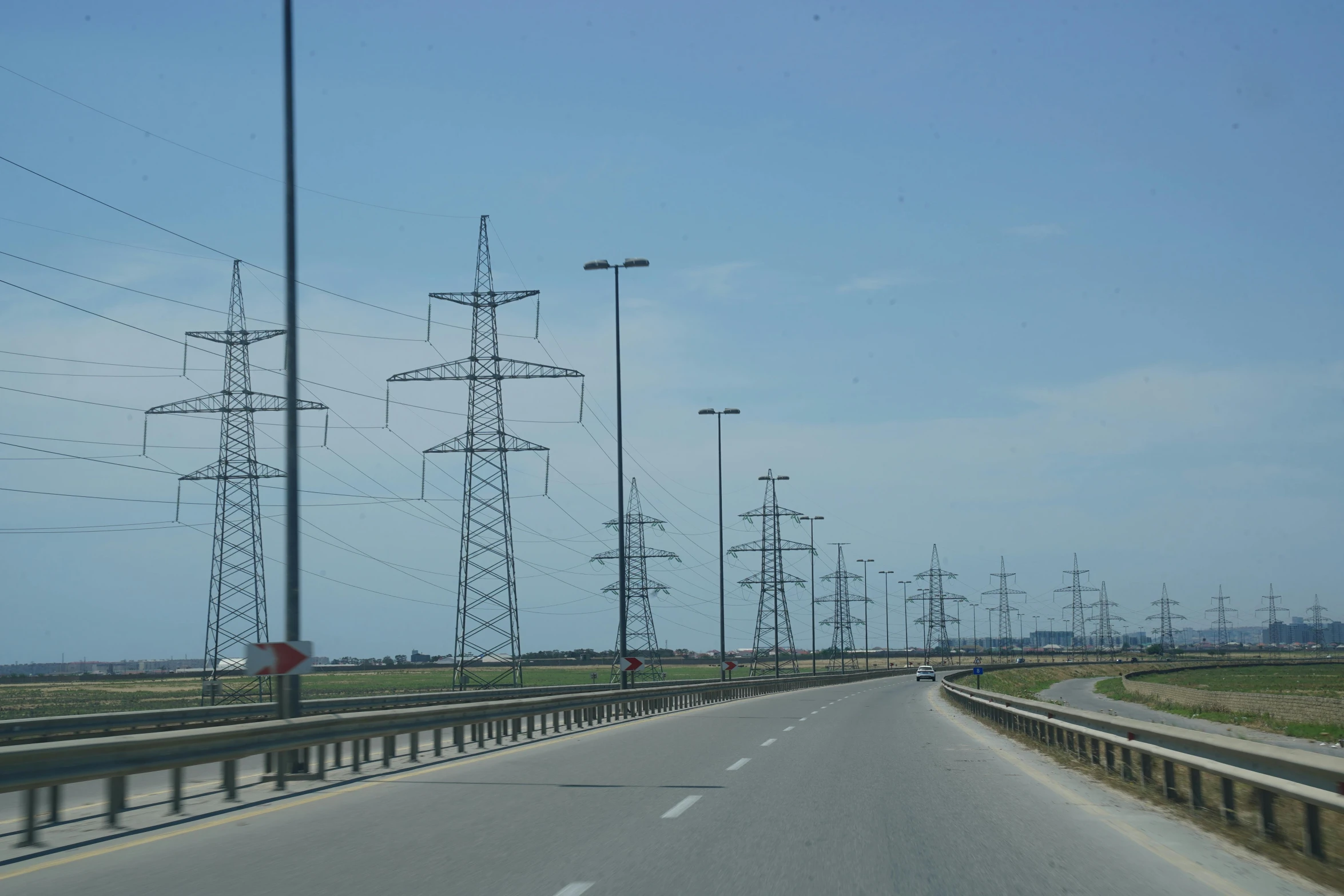 the view from a vehicle on the highway showing a bunch of wires