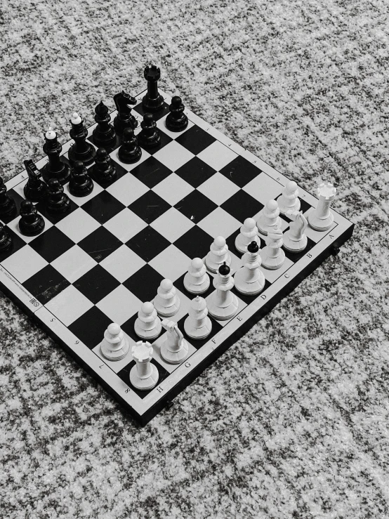 a large chess board laying on the ground
