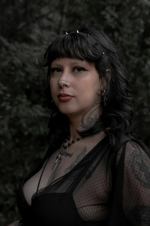 a woman with tattoos in a sheer black top