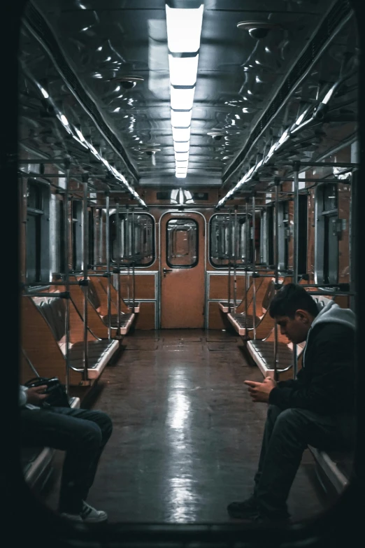 two people are sitting down in a train
