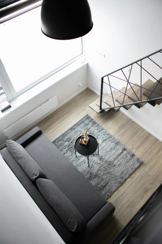 a living room with a gray sofa and table