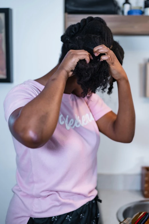 woman with a piece of id fixing her hair