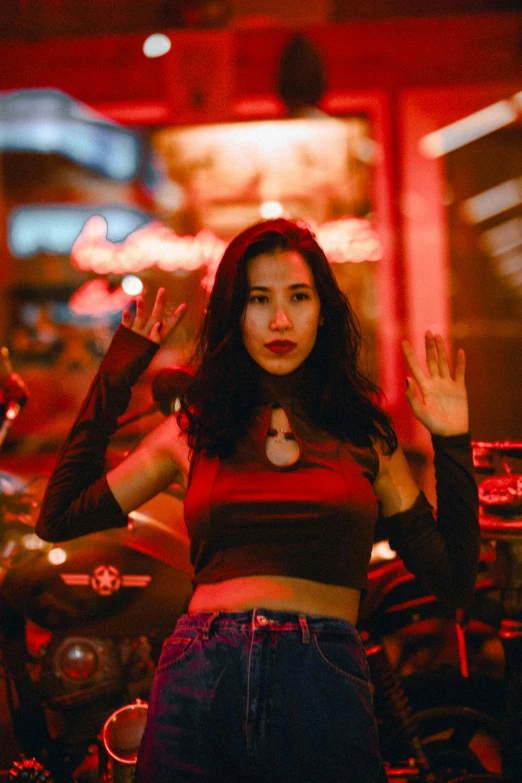 a beautiful woman standing in front of some motorcycles