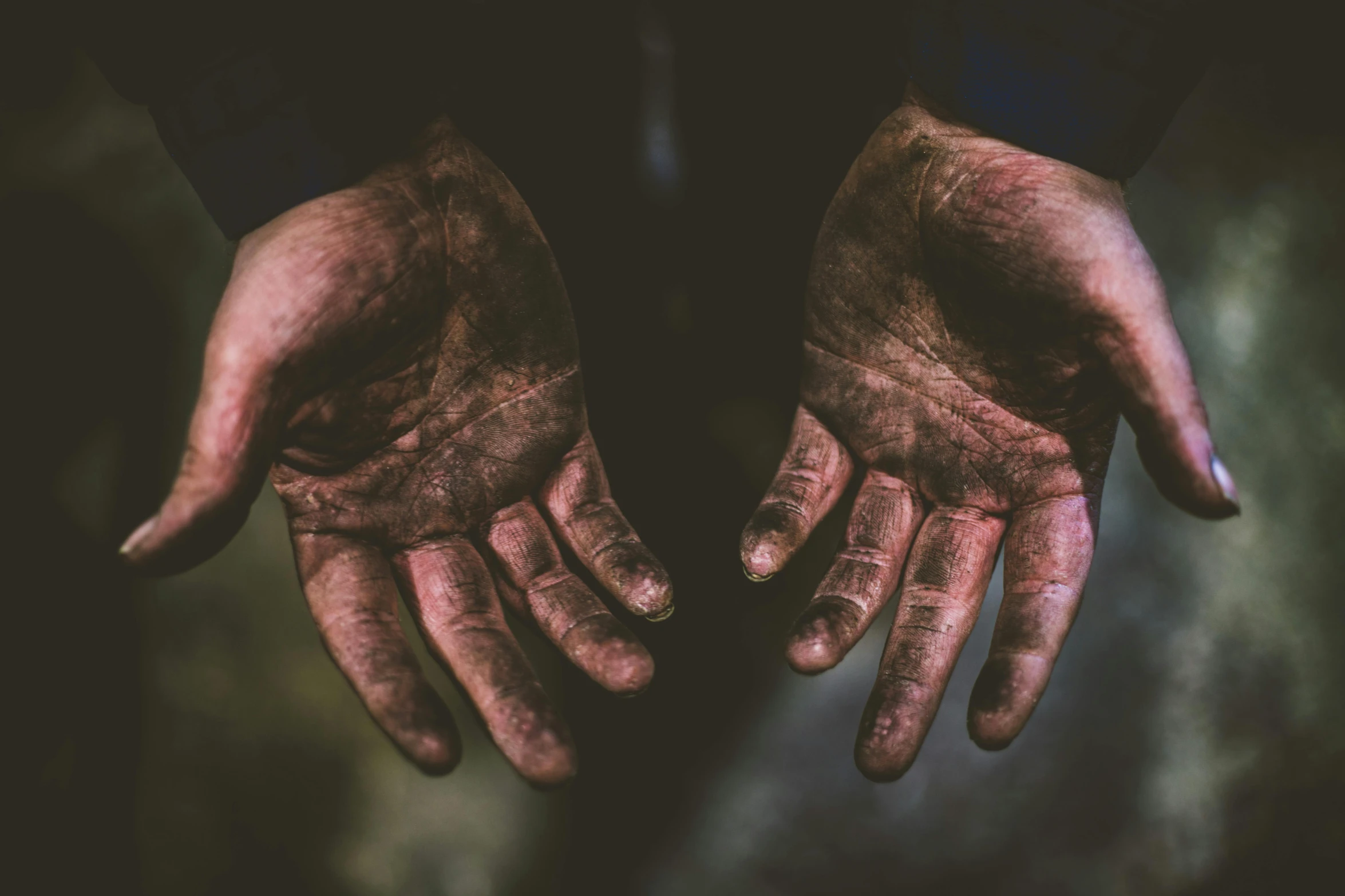 a person with dirty hands and fingers covered in dirt