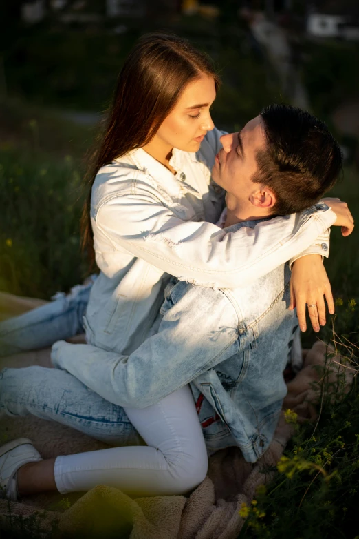 the girl is sitting down with a young man on her back