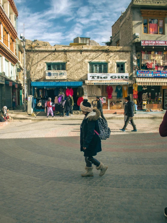 the young man is walking down the street