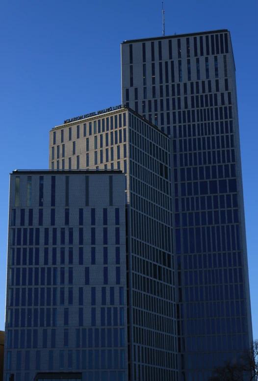 two tall buildings sit on the corner of the street