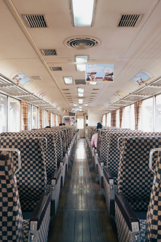 a view inside of a train with several seats and a wood floor