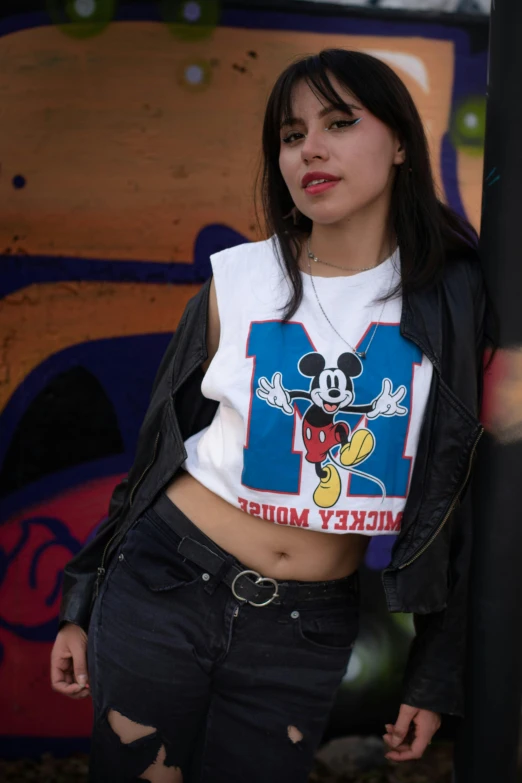 a person wearing a mickey mouse shirt posing for a picture