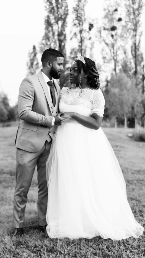 a couple dressed up in a wedding attire posing for the camera