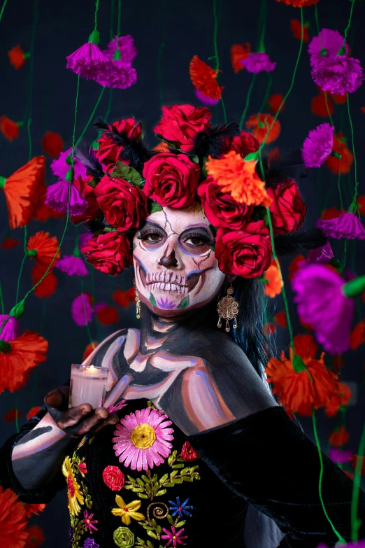 a lady with makeup and flowers painted on her head