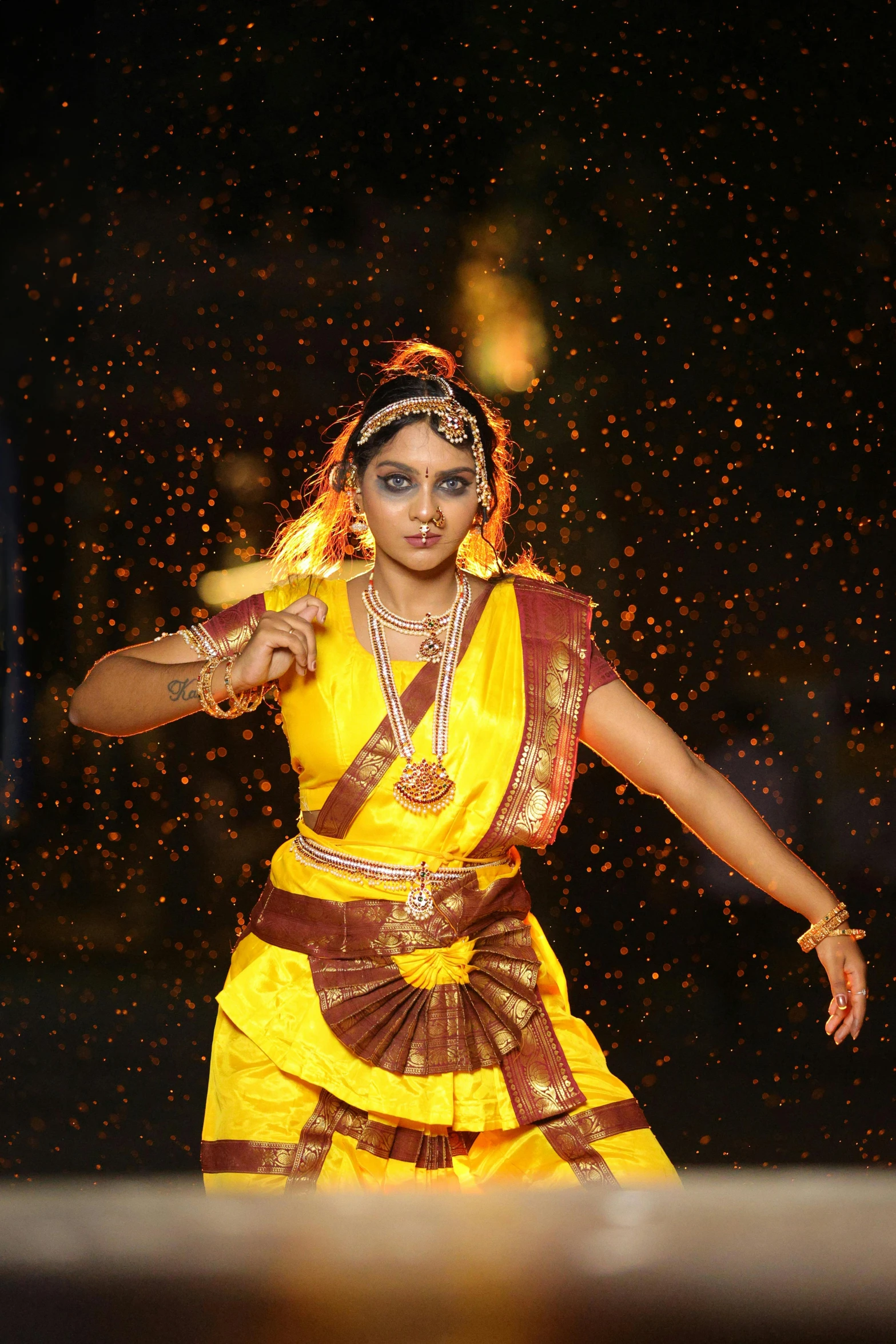 a woman is dressed in a yellow and brown outfit