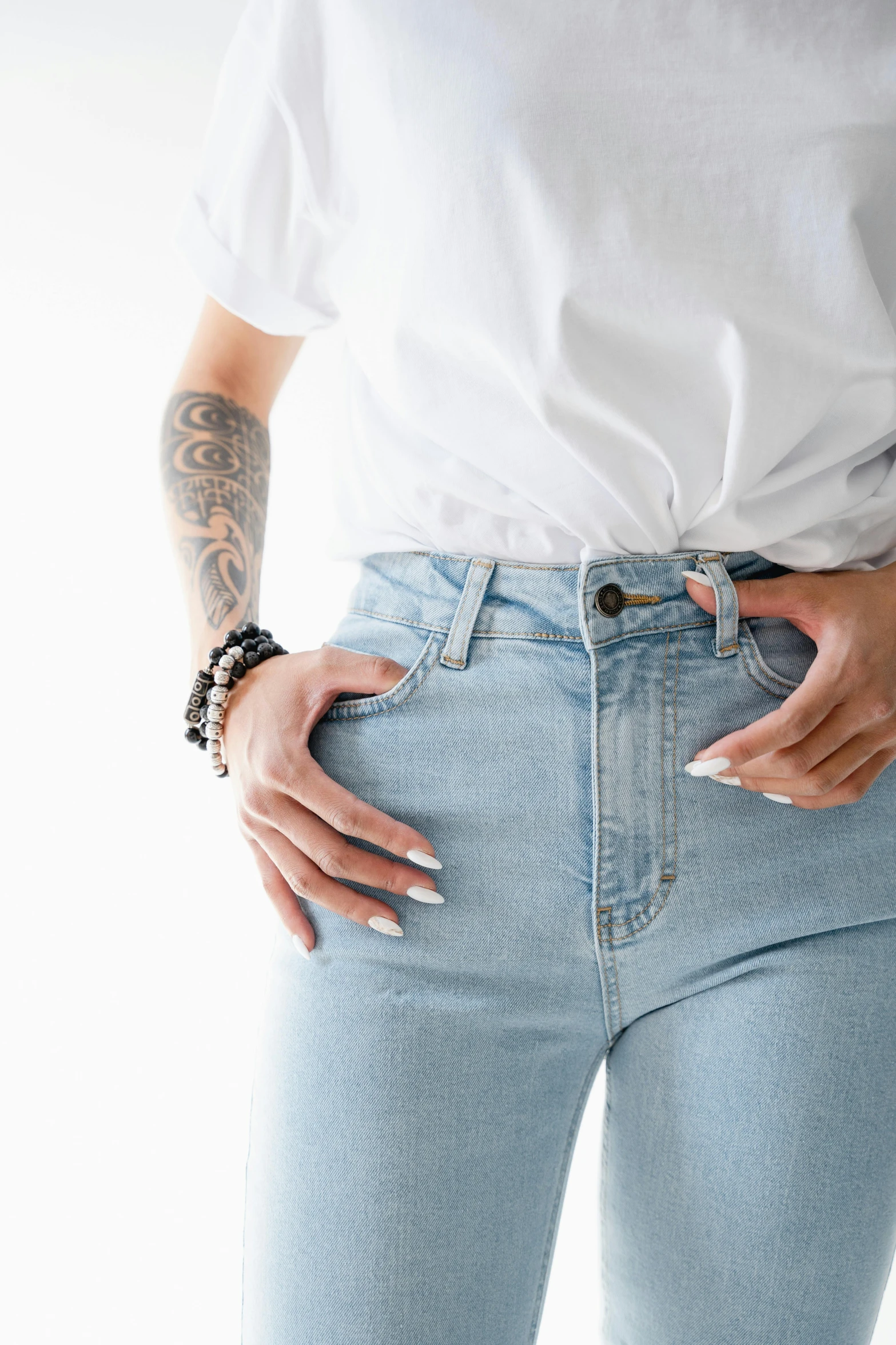 a woman wearing high waist jeans with her hands on her hip