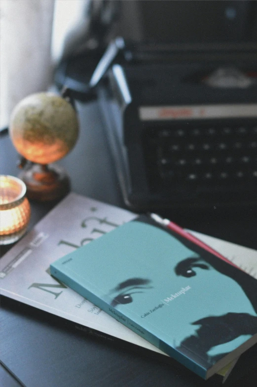 a computer and some books on a table