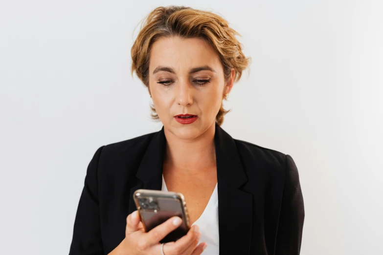 a woman looking down at her cell phone