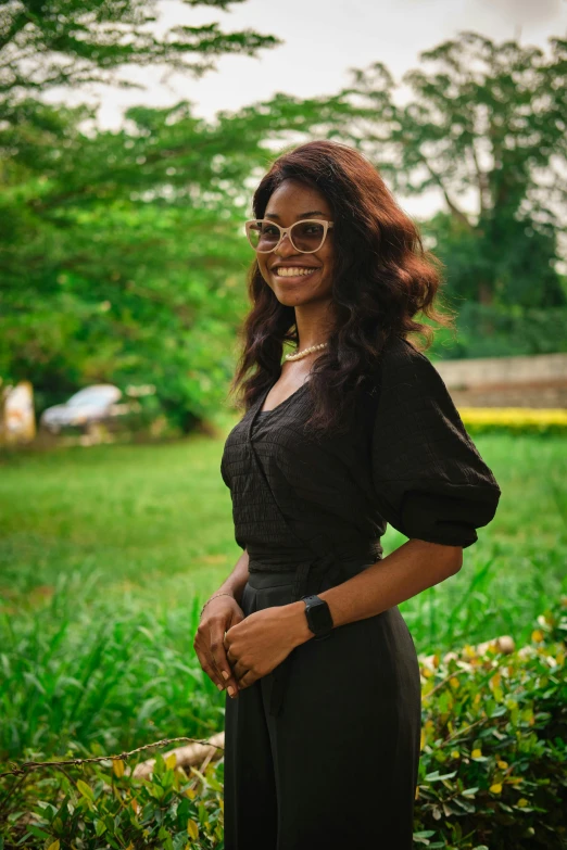 a woman in sunglasses and dress posing for a po