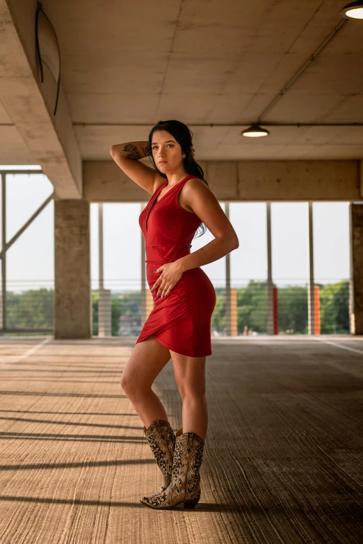 a woman is wearing a cowboy boot in an empty building