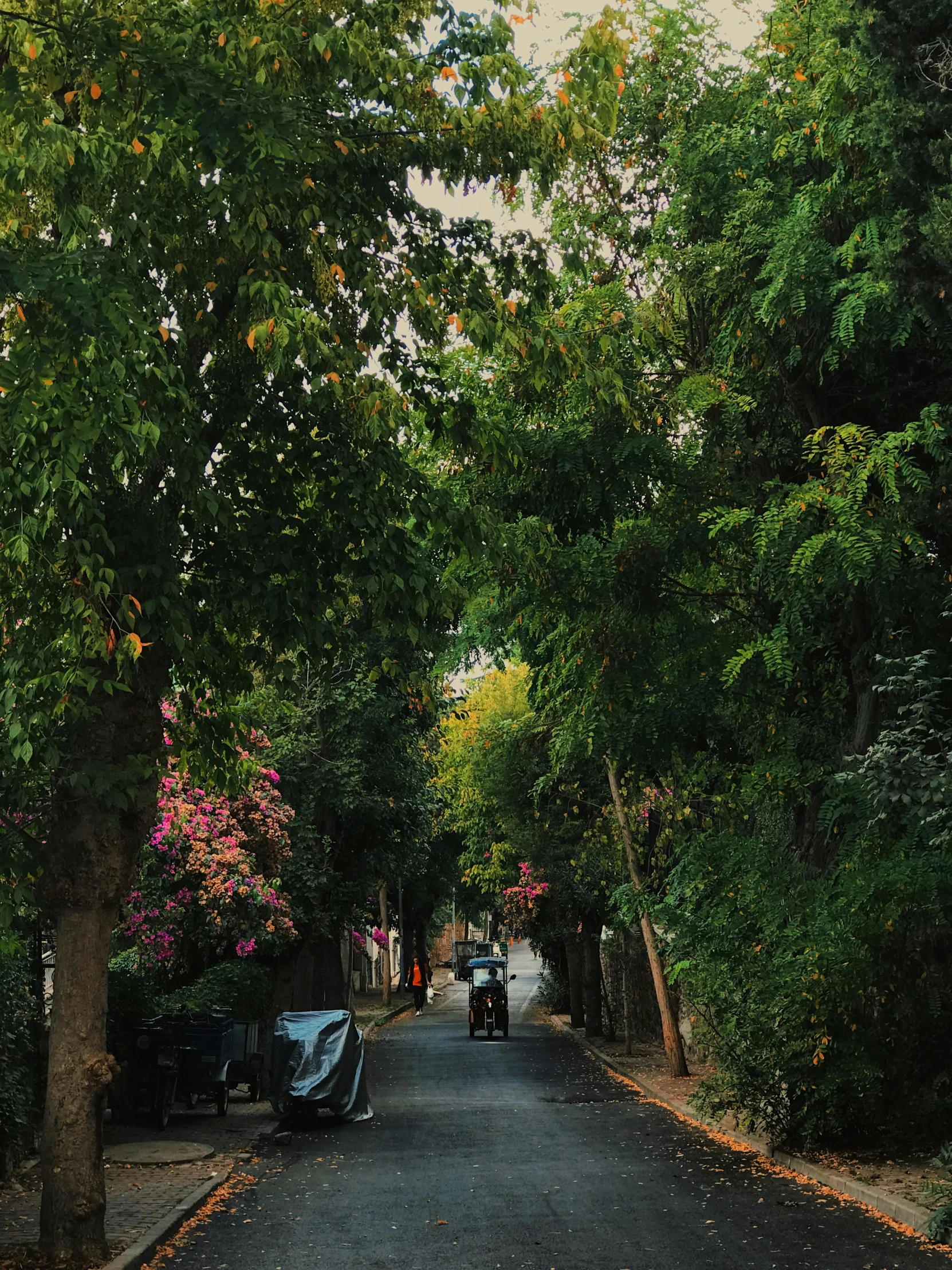 people are riding on motorcycles down an alley