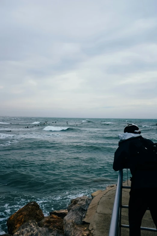 a person who is watching people on the water