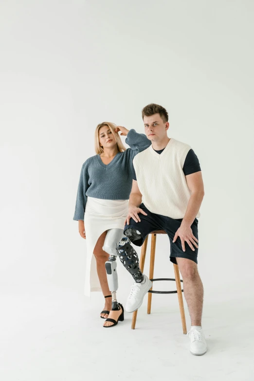 two people posing for a po on a stool
