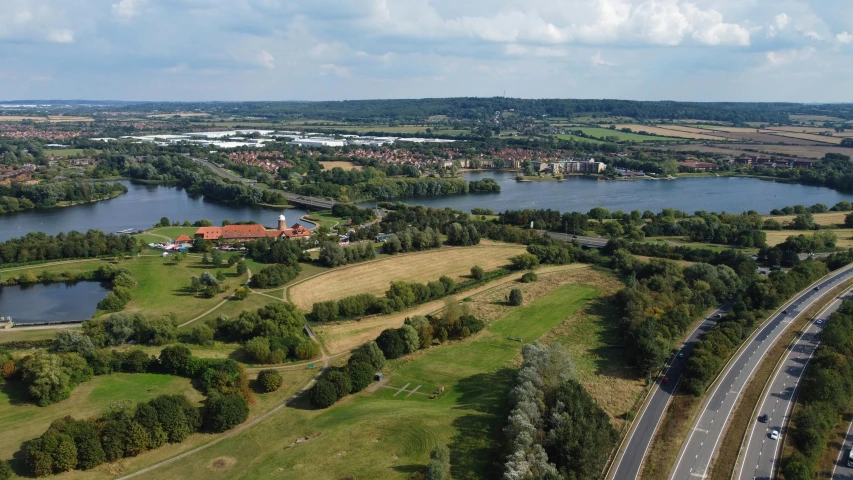 an aerial view of two streets and one road leading to a large lake