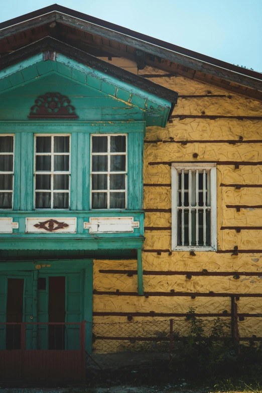 an old wooden building with windows in it