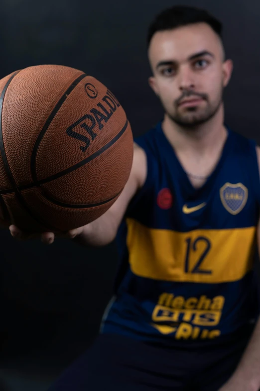 a man is holding a basketball with both hands