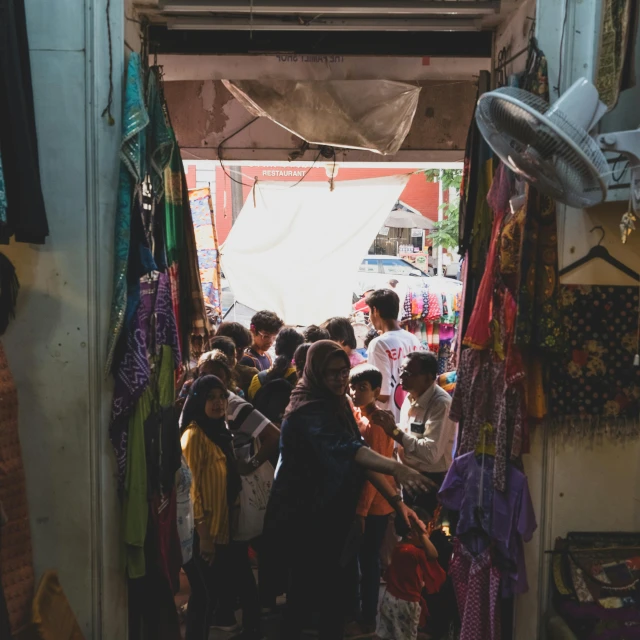 a crowd is standing outside and looking in the window