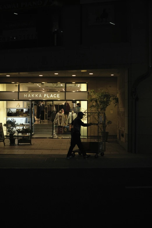 a store front at night with the shop's windows lit up