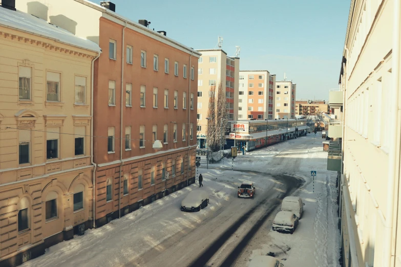 a street is covered in snow in this old looking city