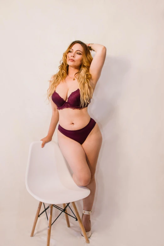 an image of woman posing on chair in lingerie