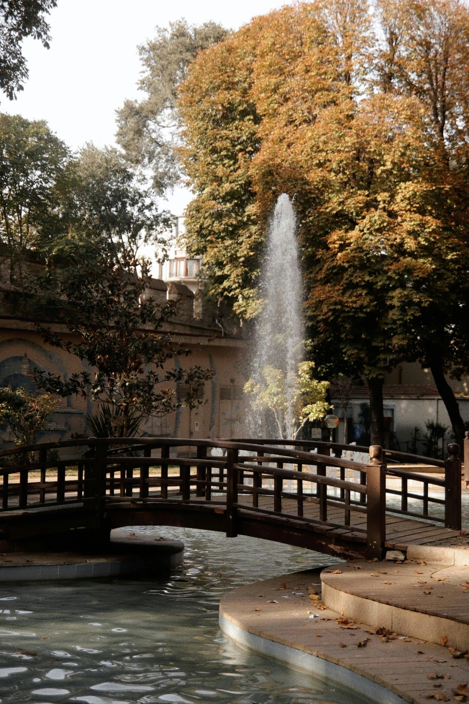 water spraying from fountain while people walk near