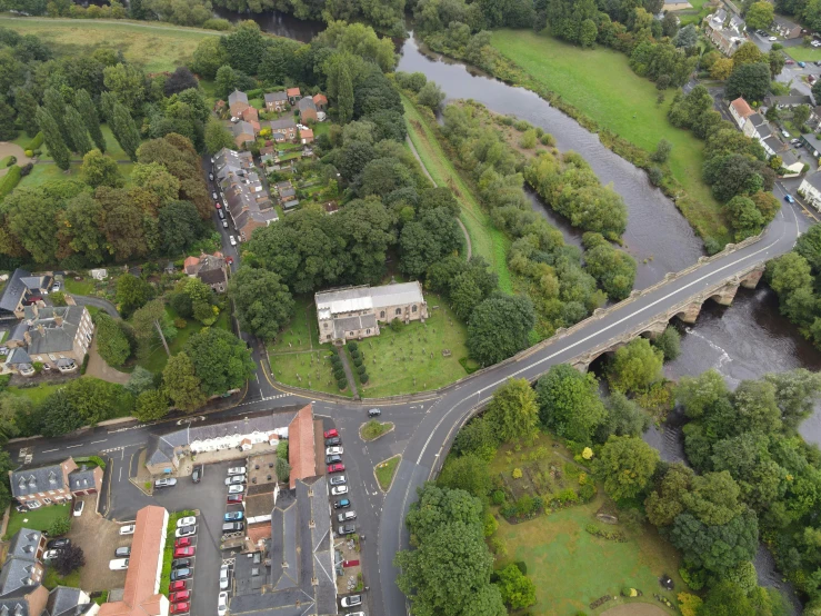 the aerial view of a street intersection with a road and cars