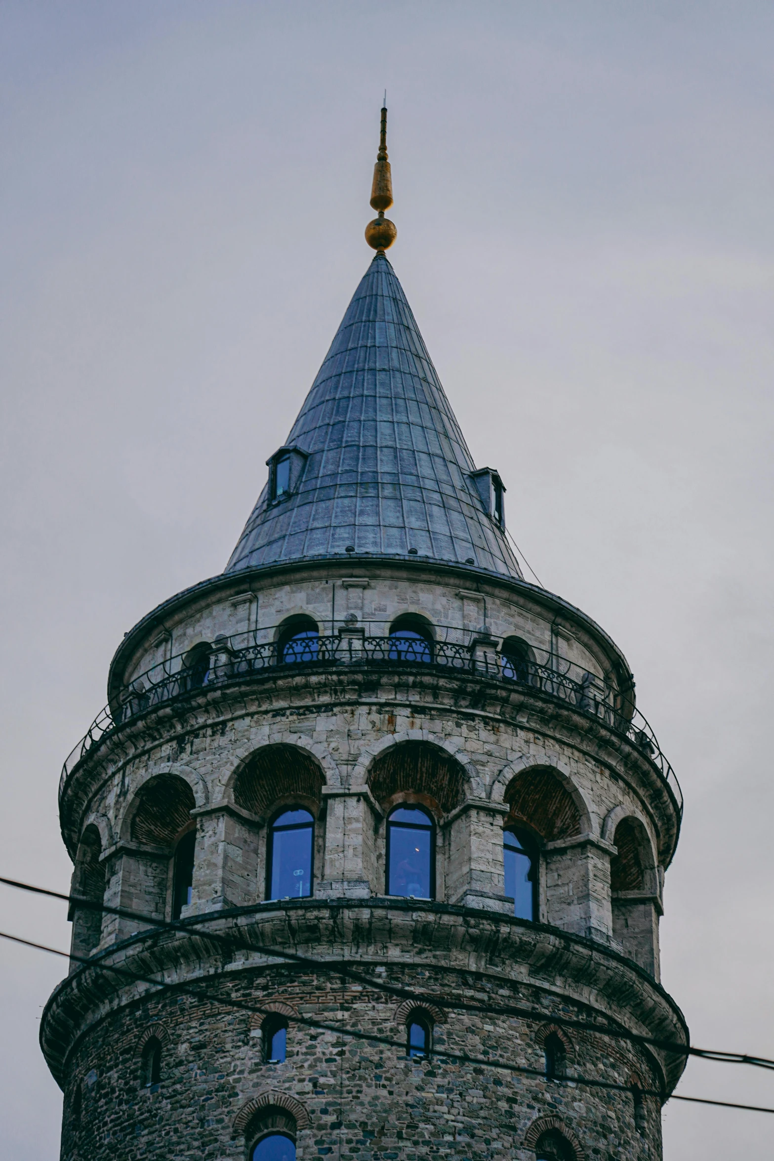 this is an old tower with a golden and black clock on top