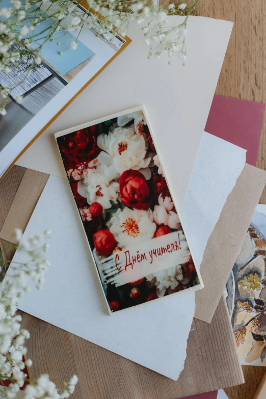 an open greeting card is displayed on top of pieces of paper