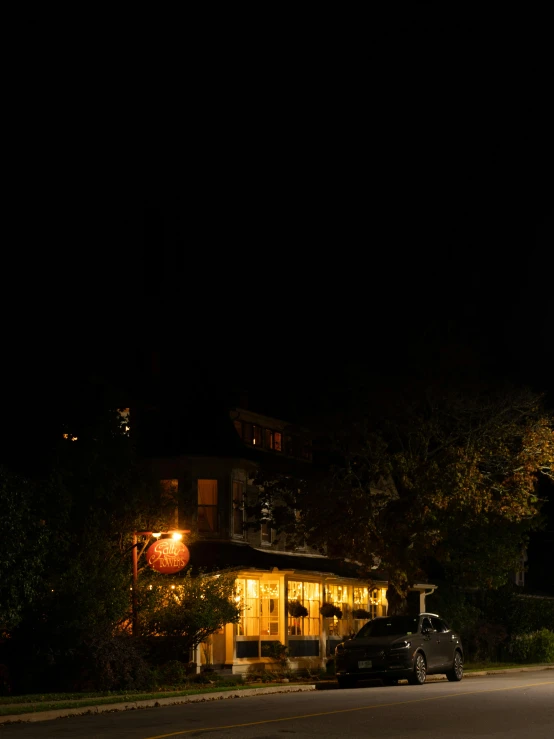 a po of a house at night with streetlights on