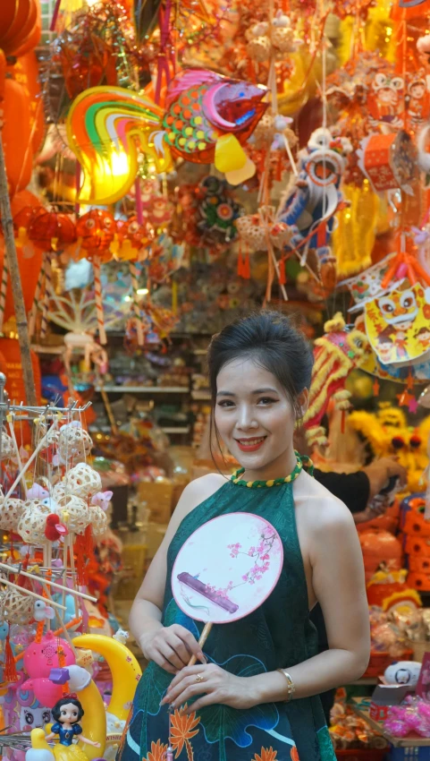 a woman in a green dress with a ping pong paddle