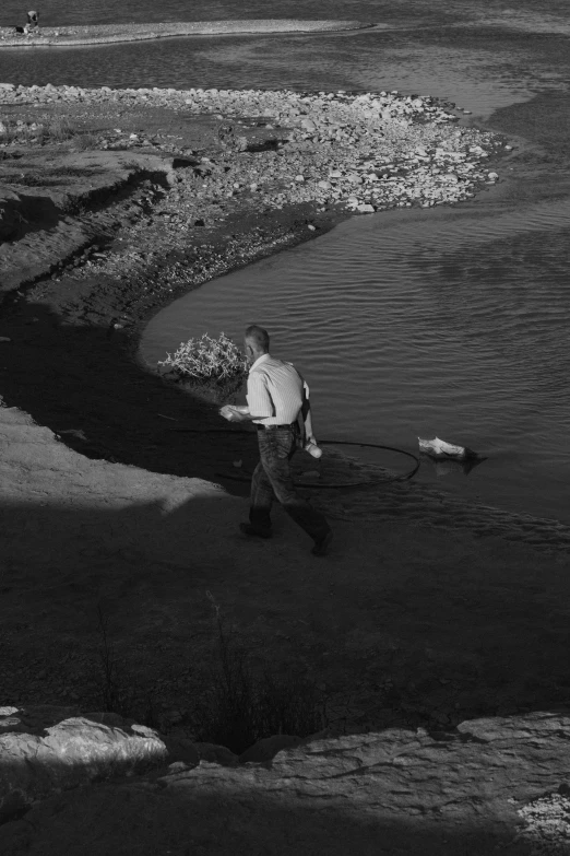 a man walks on the beach carrying a net