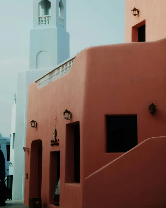 a person standing near a building next to some lights