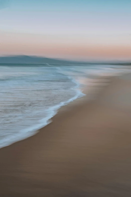 a beach that has waves rolling in on it