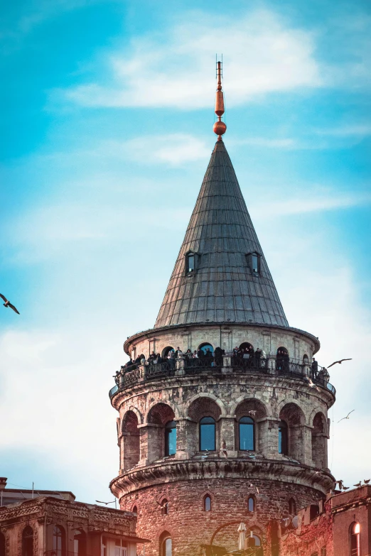 a tower with several people looking up at the sky