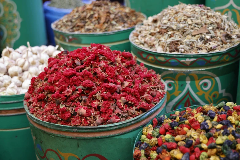 several buckets filled with various kinds of flowers